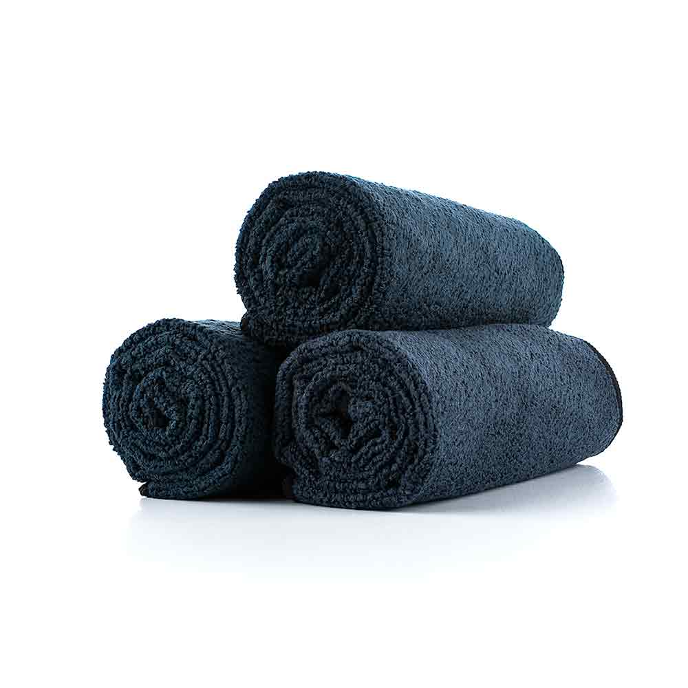 3 black towels rolled up